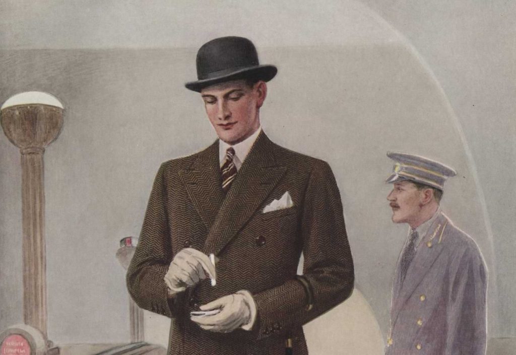 A British man in a Bowler hat and a double breasted coat at a railway station